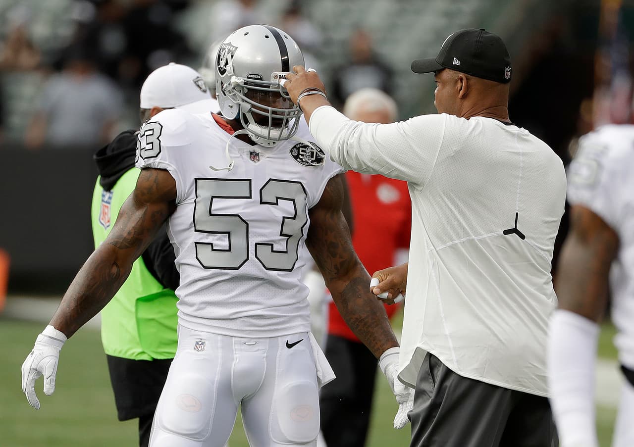Oakland Raiders linebacker NaVorro Bowman (53) talks with defensive coordinator Ken Norton Jr. before an NFL football game against the Kansas City Chiefs in Oakland, Calif., Thursday, Oct. 19, 2017. (AP Photo/Marcio Jose Sanchez)