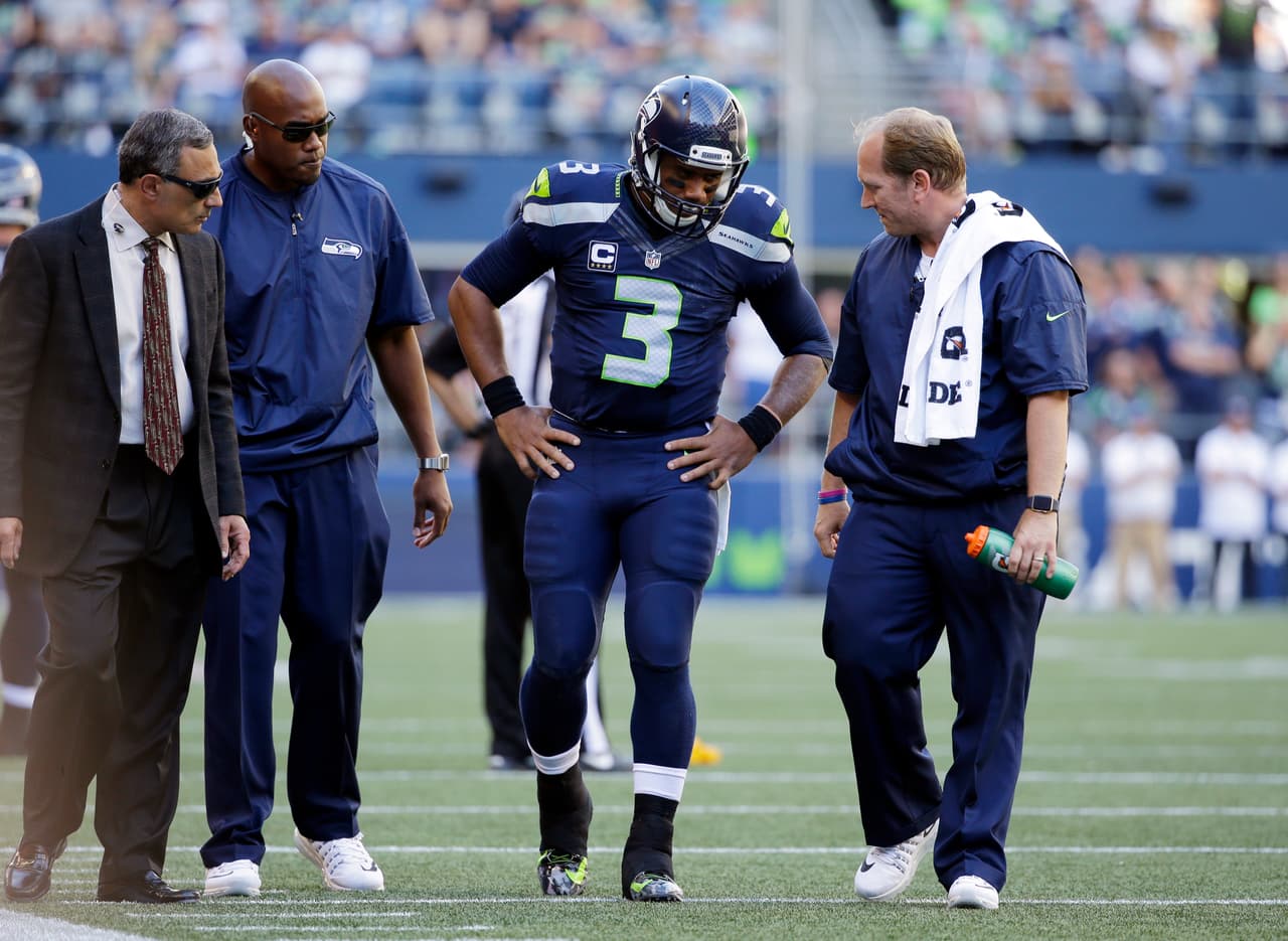 Seattle Seahawks quarterback Russell Wilson (3) is assisted off the field after being brought down against the San Francisco 49ers in the second half of an NFL football game, Sunday, Sept. 25, 2016, in Seattle. (AP Photo/Ted S. Warren)
