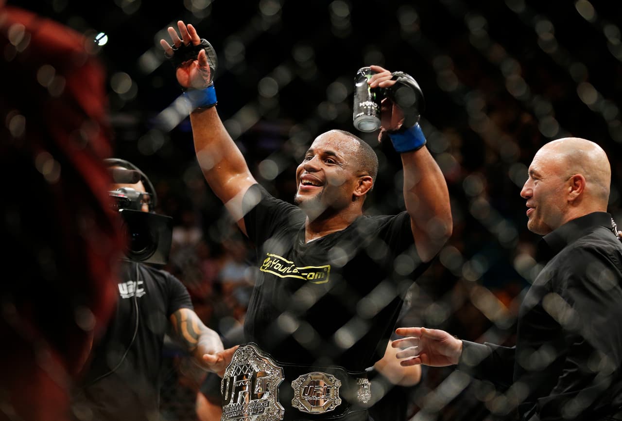 Daniel Cormier celebrates after defeating Anthony Johnson in their light heavyweight mixed martial arts title bout at UFC 187 on Saturday, May 23, 2015, in Las Vegas. (AP Photo/John Locher)
