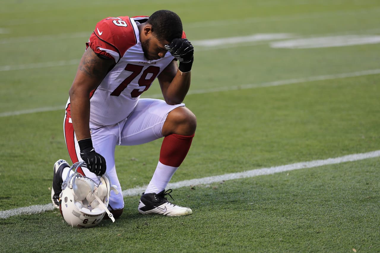DENVER, CO - AUGUST 29: Defensive tackle David Carter #79 of the Arizona Cardinals pauses on the field prior to facing the Denver Broncos during preseason action at Sports Authority Field at Mile High on August 29, 2013 in Denver, Colorado. The Cardinals defeated the Broncos 32-24. (Photo by Doug Pensinger/Getty Images)