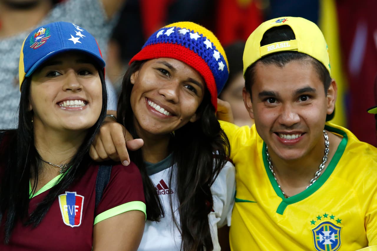 MERIDA, VENEZUELA - OCTOBER 11: Fans of Venezuela and Brazil cheer for their team during a match between Venezuela and Brazil as part of FIFA 2018 World Cup Qualifiers at Metropolitano Stadium on October 11, 2016 in Merida, Venezuela. (Photo by Nelson Pulido/LatinContent/Getty Images)