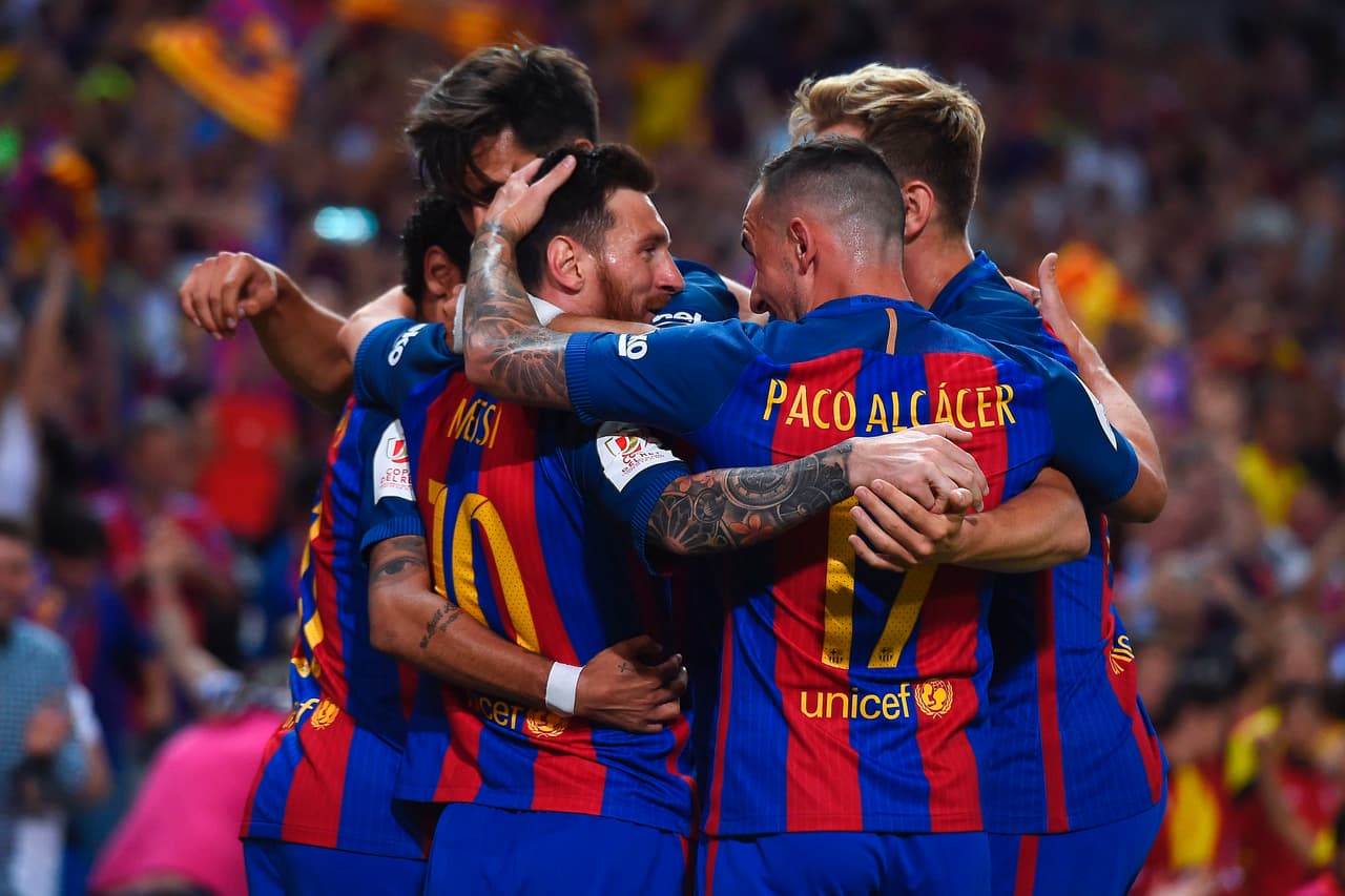 Barcelona's Argentinian forward Lionel Messi (L) celebrates with teammates after scoring the opener during the Spanish Copa del Rey (King's Cup) final football match FC Barcelona vs Deportivo Alaves at the Vicente Calderon stadium in Madrid on May 27, 2017. / AFP PHOTO / Josep LAGO (Photo credit should read JOSEP LAGO/AFP/Getty Images)