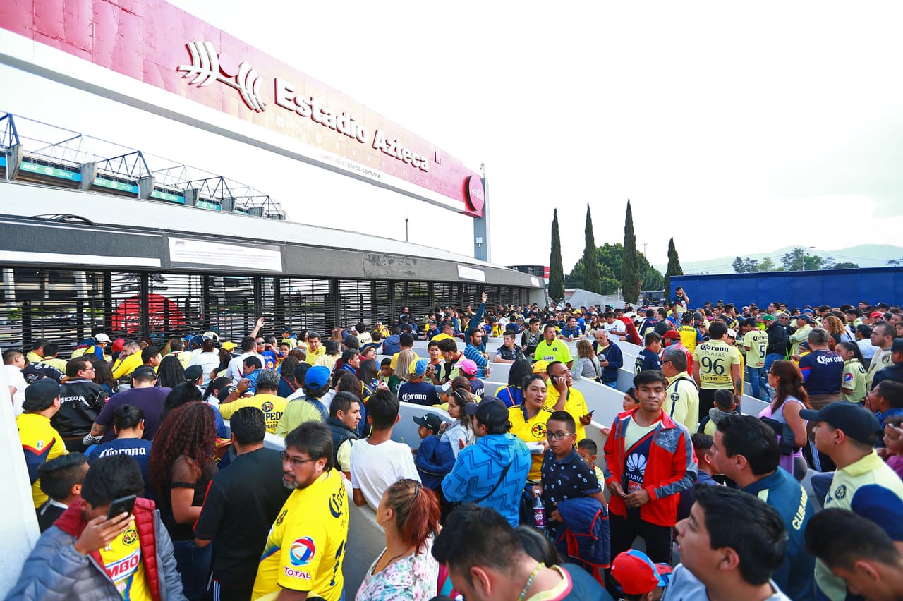 Los fanáticos del América en las afueras del Estadio Azteca esperan por la apertura del inmueble para la Fiesta Azulcrema.