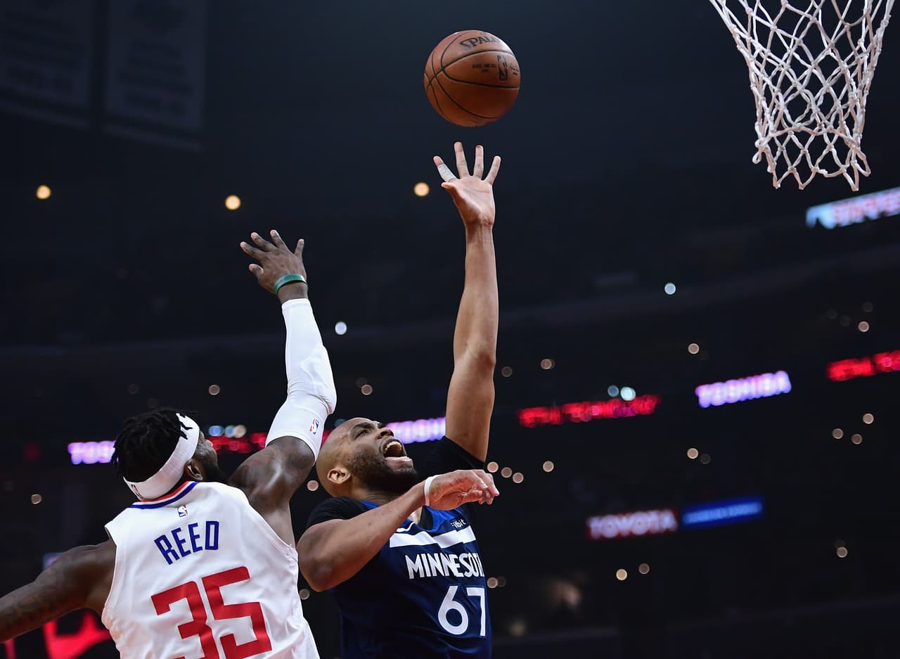 LOS ANGELES, CA - JANUARY 22: Taj Gibson #67 of the Minnesota Timberwolves scores on Willie Reed #35 of the LA Clippers during the first half at Staples Center on January 22, 2018 in Los Angeles, California. (Photo by Harry How/Getty Images)