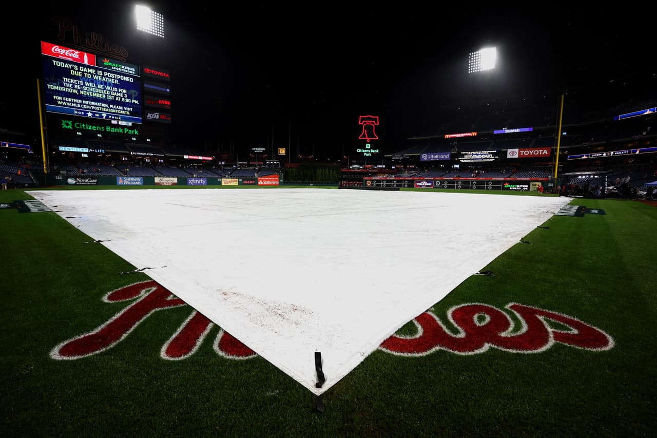 PHILADELPHIA, PENNSYLVANIA - OCTOBER 31: The tarp covers the field following the postponement of Game Three of the 2022 World Series between the Philadelphia Phillies and Houston Astros at Citizens Bank Park on October 31, 2022 in Philadelphia, Pennsylvania. (Photo by Al Bello/Getty Images)