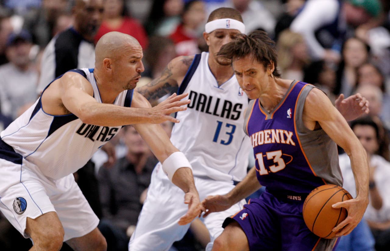 Phoenix Suns guard Steve Nash (13) looks for room against Dallas Mavericks guard Jason Kidd, left, and guard Delonte West (13) during the first half of an NBA basketball game on Wednesday, Jan. 4, 2012, in Dallas. (AP Photo/Brandon Wade)