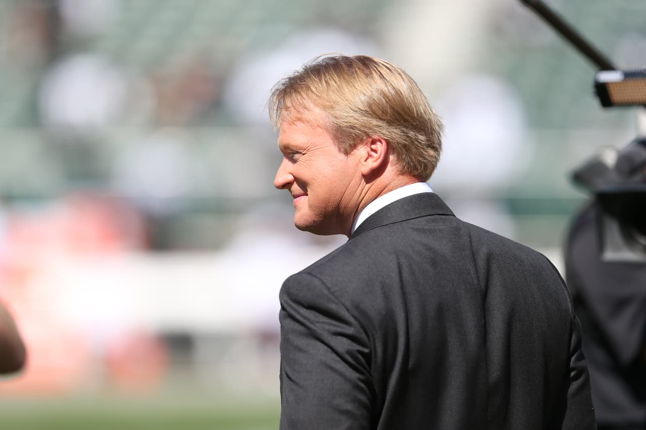 Former Oakland Raiders head coach and current ESPN Monday Night Football commentator John Gruden talks to fans before an NFL preseason football game between the Oakland Raiders and Dallas Cowboys in Oakland, CA Monday, Aug. 13, 2012. (AP Photo/Tom Hauck)