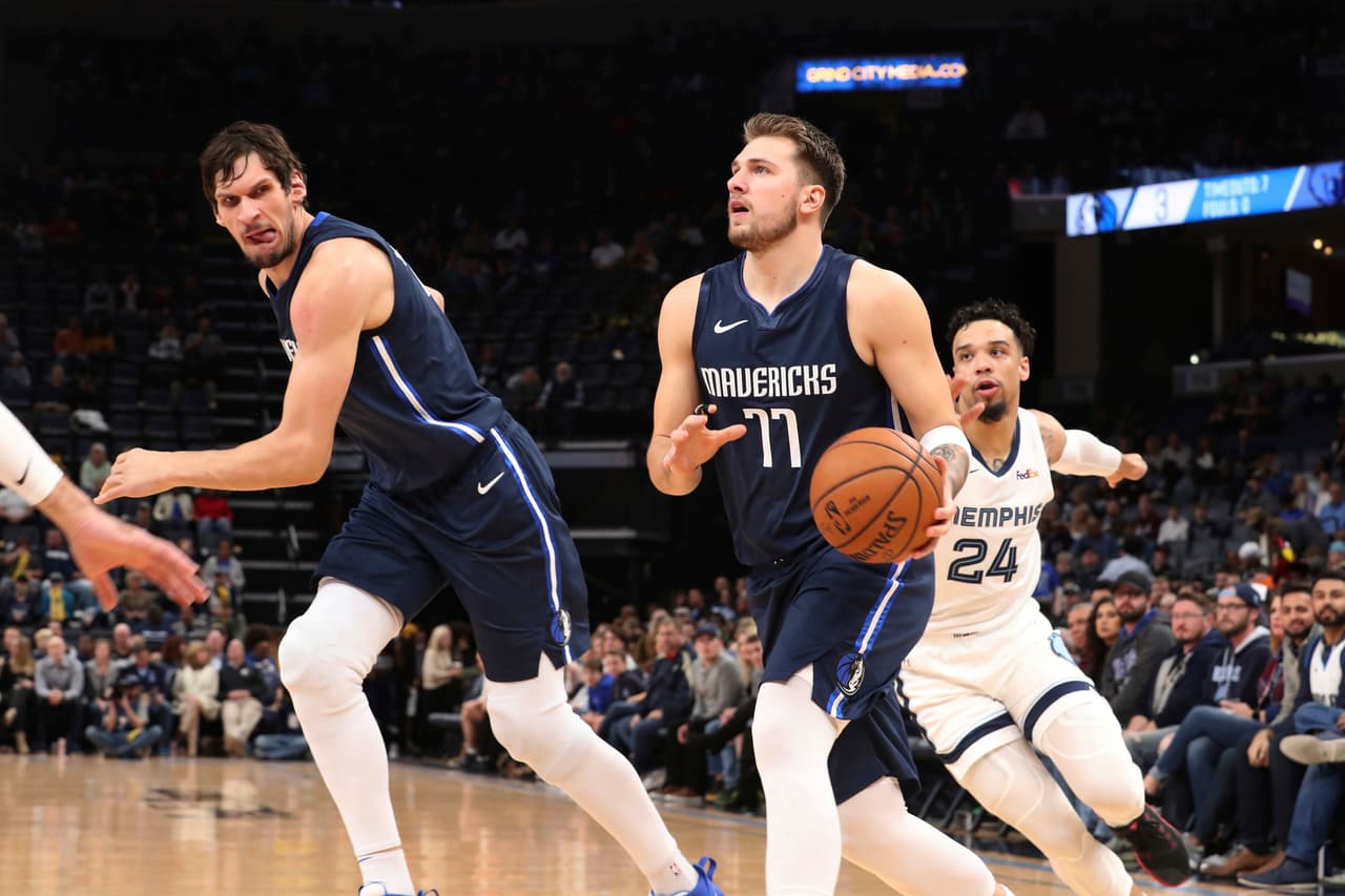 Memphis Grizzlies' Dillon Brooks (24) tries to catch Dallas Mavericks; Luka Doncic (77) during the first half of an NBA basketball game Saturday, Nov. 9, 2019, in Memphis, Tenn. (AP Photo/Karen Pulfer Focht)