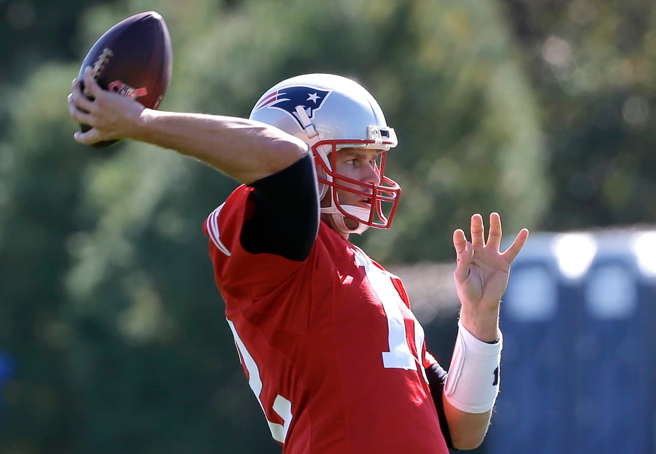 New England Patriots quarterback Tom Brady (12) winds up for a pass during an NFL football team practice Wednesday, Oct. 5, 2016, in Foxborough, Mass. (AP Photo/Steven Senne)