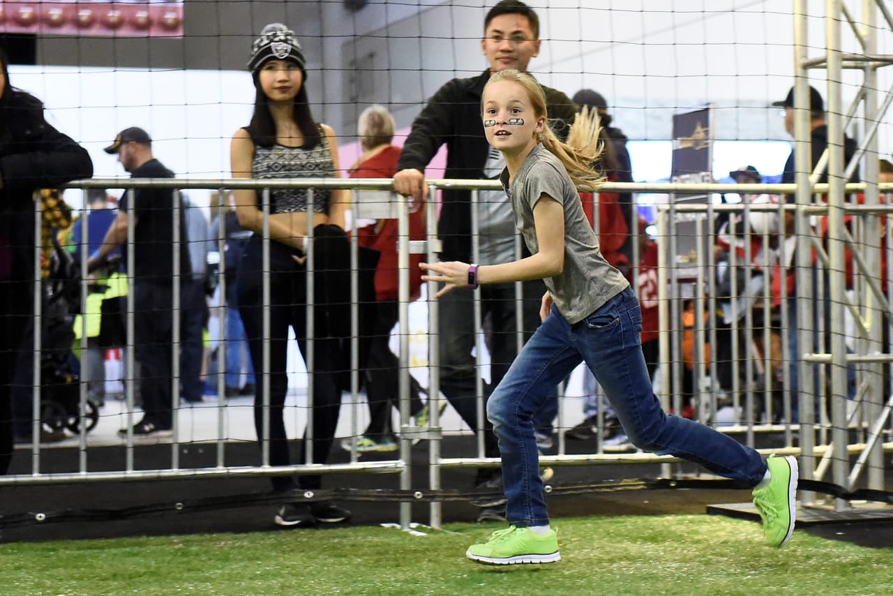 Sunday, January 31, 2016: A fan runs to make a catch at the NFL Experience during the week long NFL Super Bowl 50 celebration in San Francisco, California. Eric Canha/CSM (Cal Sport Media via AP Images)