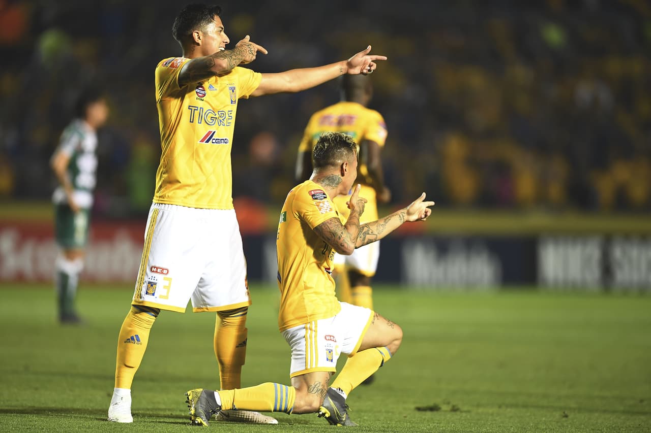 Y en una jugada polémica, Tigres se fue adelante en el marcador apenas a los 8 minutos de partido por conducto del chileno Eduardo Vargas, quien festeja en la imagen con Carlos Salcedo (izq).