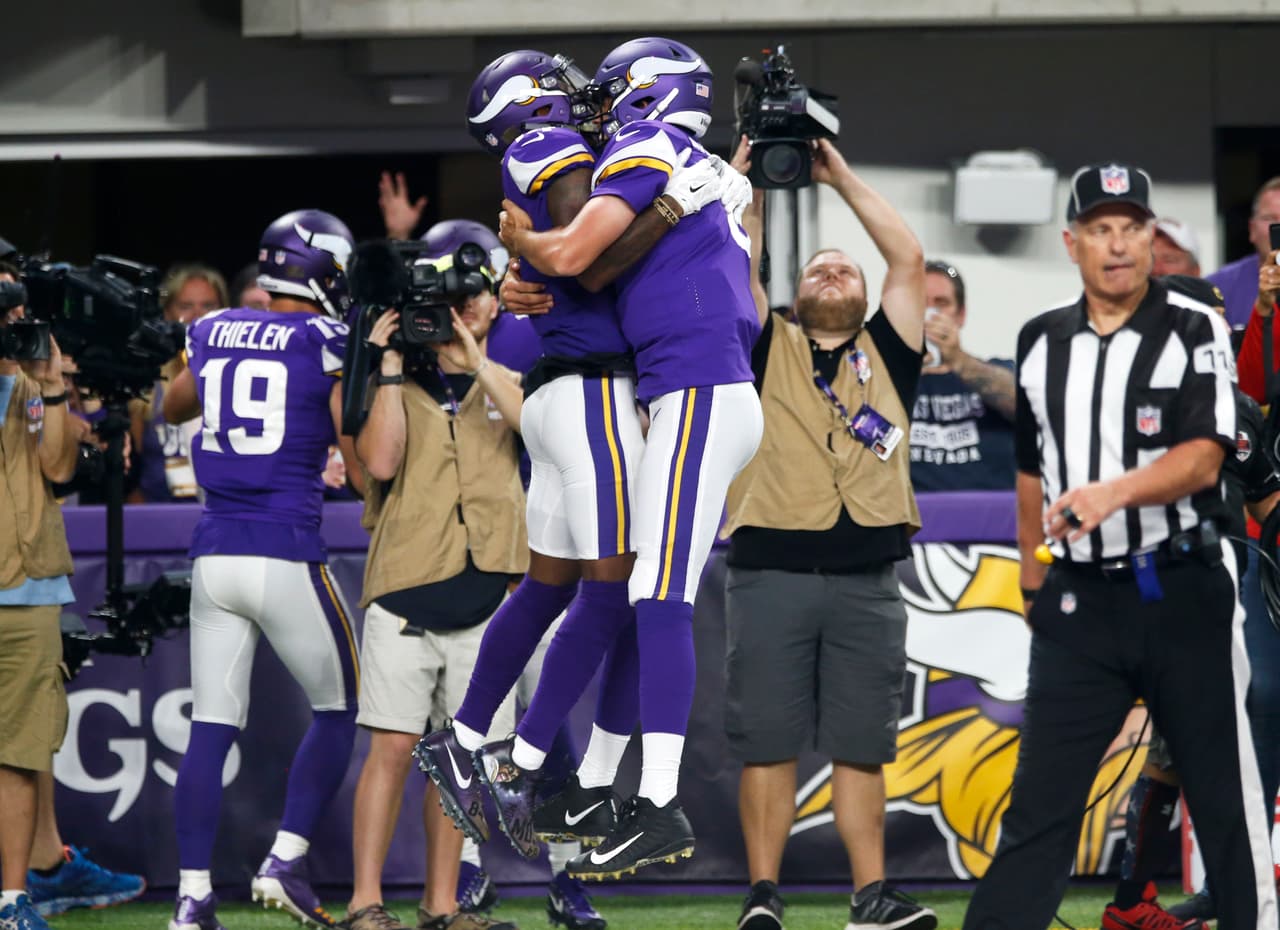Minnesota Vikings wide receiver Stefon Diggs, left, celebrates with teammate Sam Bradford after catching an 18-yard touchdown pass during the first half of an NFL football game against the New Orleans Saints, Monday, Sept. 11, 2017, in Minneapolis. (AP Photo/Jim Mone)