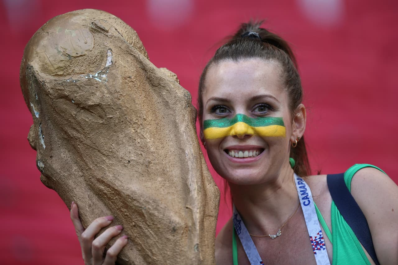 A supporter poses with a replica of the World Cup trophy ahead of the Russia 2018 World Cup quarter-final football match between Brazil and Belgium at the Kazan Arena in Kazan on July 6, 2018. (Photo by Roman Kruchinin / AFP) / RESTRICTED TO EDITORIAL USE - NO MOBILE PUSH ALERTS/DOWNLOADS (Photo credit should read ROMAN KRUCHININ/AFP/Getty Images)