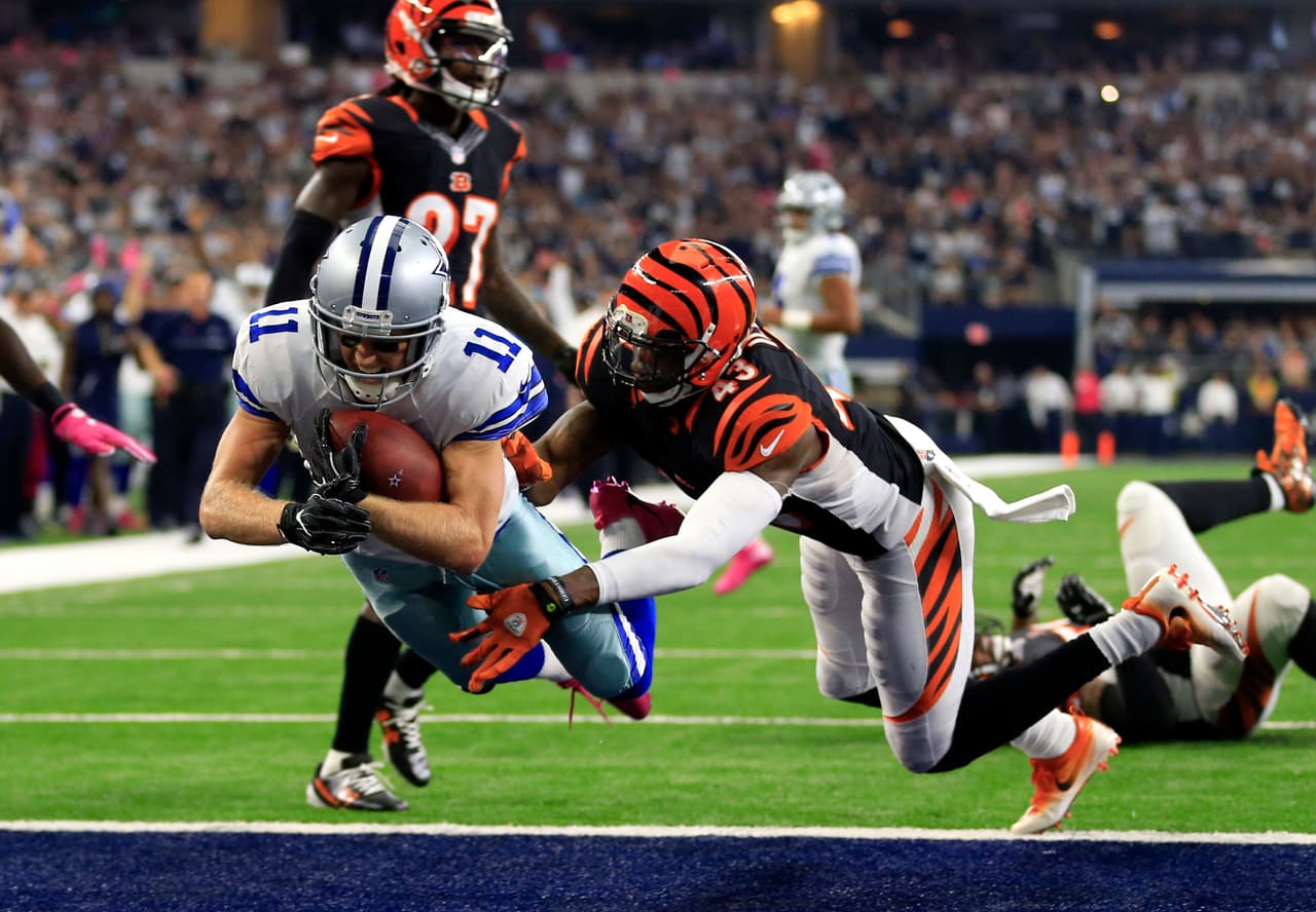 Dallas Cowboys wide receiver Cole Beasley (11) leaps into the end zone for a touchdown after catching a pass as Cincinnati Bengals free safety George Iloka (43) defends in the first half of an NFL football game, Sunday, Oct. 9, 2016, in Arlington, Texas. (AP Photo/Ron Jenkins)