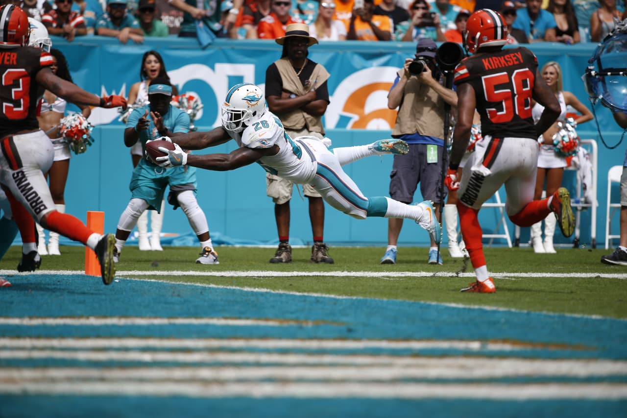 Miami Dolphins running back Damien Williams (26) stretches for a touchdown during the second half of an NFL football game against the Cleveland Browns, Sunday, Sept. 25, 2016, in Miami Gardens, Fla. (AP Photo/Wilfredo Lee)