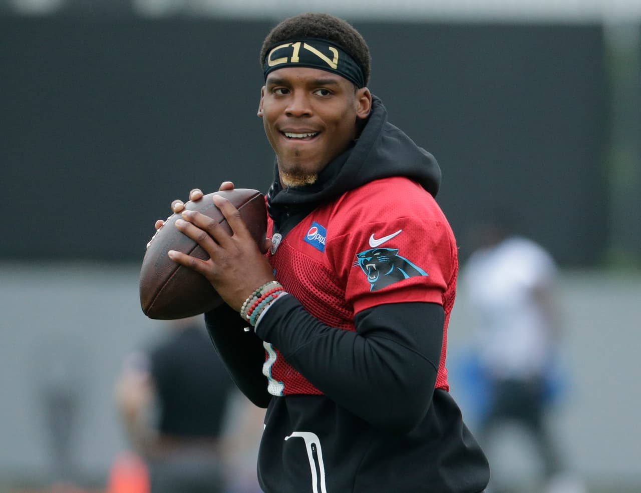 Carolina Panthers' Cam Newton (1) runs a drill in practice during the NFL football team's organized team activities in Charlotte, N.C., Tuesday, May 30, 2017. (AP Photo/Chuck Burton)