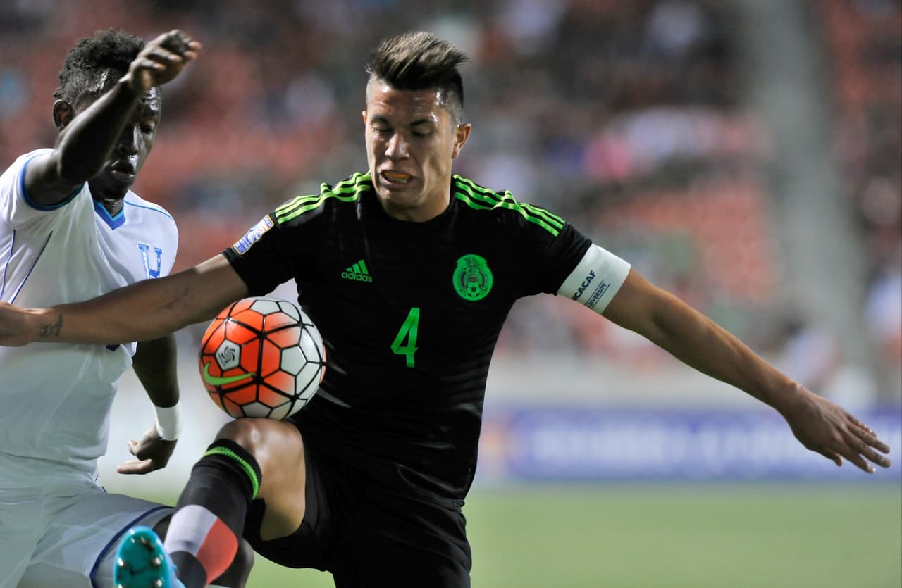 SANDY UT- OCTOBER 13: Carlos Salcedo #4 of Mexico tries to keep the ball away from Alberth Elis #17 of Honduras during the first half of the final CONCACAF Olympic Qualifying match at Rio Tinto Stadium on October 13, 2015 in Sandy, Utah. (Photo by Gene Sweeney Jr/Getty Images)