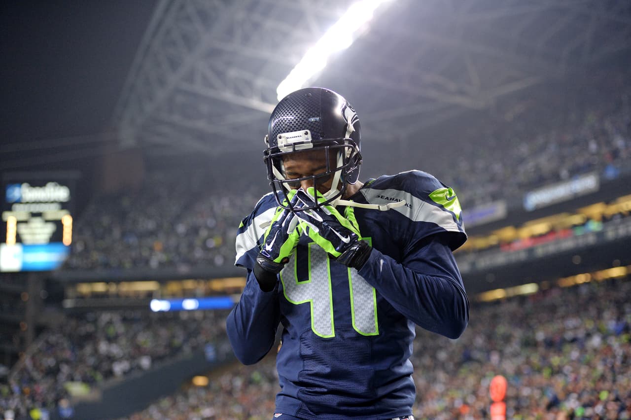 Seattle Seahawks defensive back Byron Maxwell (41) is overcome with emotion after the NFC Championship game against the San Francisco 49ers on Sunday, Jan. 19, 2014, in Seattle. The Seahawks won the game, 23-17. (AP Photo/Greg Trott)