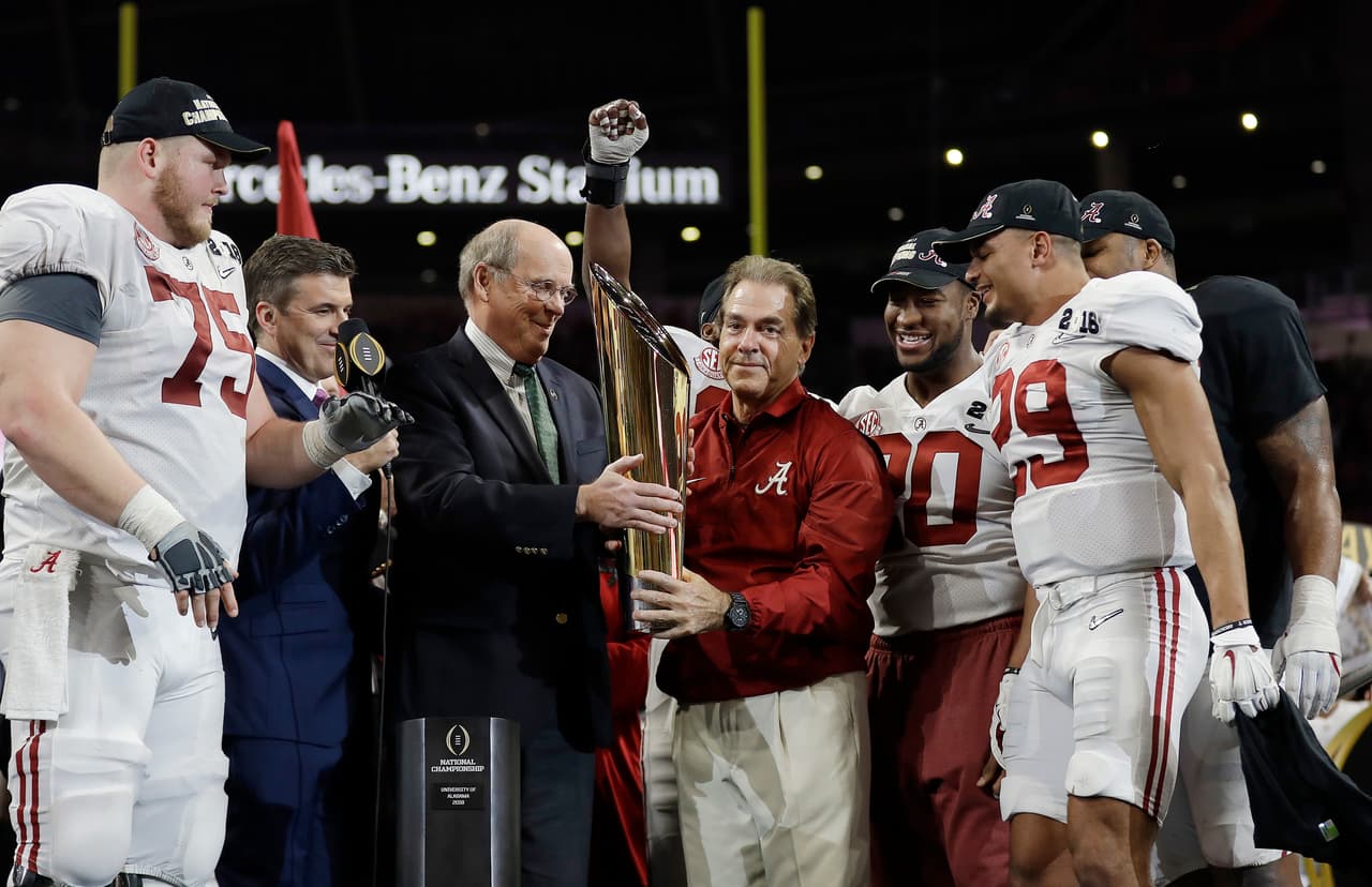 Alabama head coach Nick Saban holds up the championship trophy after overtime of the NCAA college football playoff championship game against Georgia, Monday, Jan. 8, 2018, in Atlanta. Alabama won 26-23. (AP Photo/David J. Phillip)