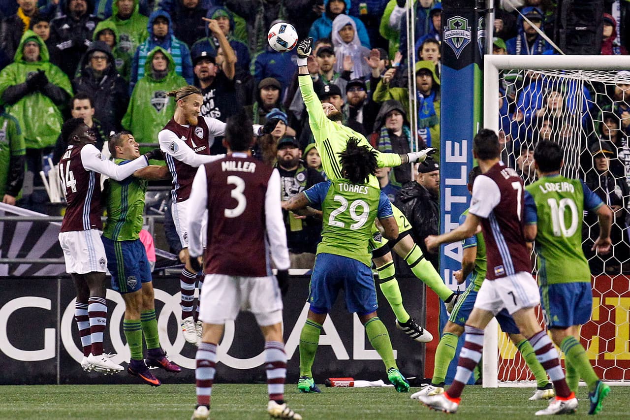 Nov 22, 2016; Seattle, WA, USA; Seattle Sounders FC goalkeeper Stefan Frei (24) punches away a corner kick from Colorado Rapids defender Jared Watts (33) during the first half in the first leg of the MLS Western Conference Championship at CenturyLink Field. Colorado Rapids midfielder Dominique Badji (14) and Seattle Sounders FC midfielder Jordan Morris (13) follow the play at left. Mandatory Credit: Joe Nicholson-USA TODAY Sports
