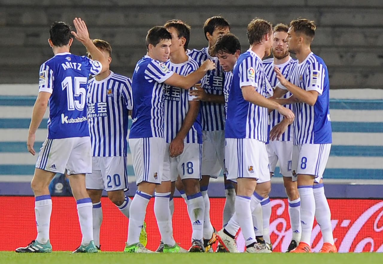 Real Sociedad's players celebrate after scoring their team's second goal during the Spanish league football match Real Sociedad vs Valencia CF at the Anoeta stadium in San Sebastian on September 24, 2017. / AFP PHOTO / ANDER GILLENEA (Photo credit should read ANDER GILLENEA/AFP/Getty Images)