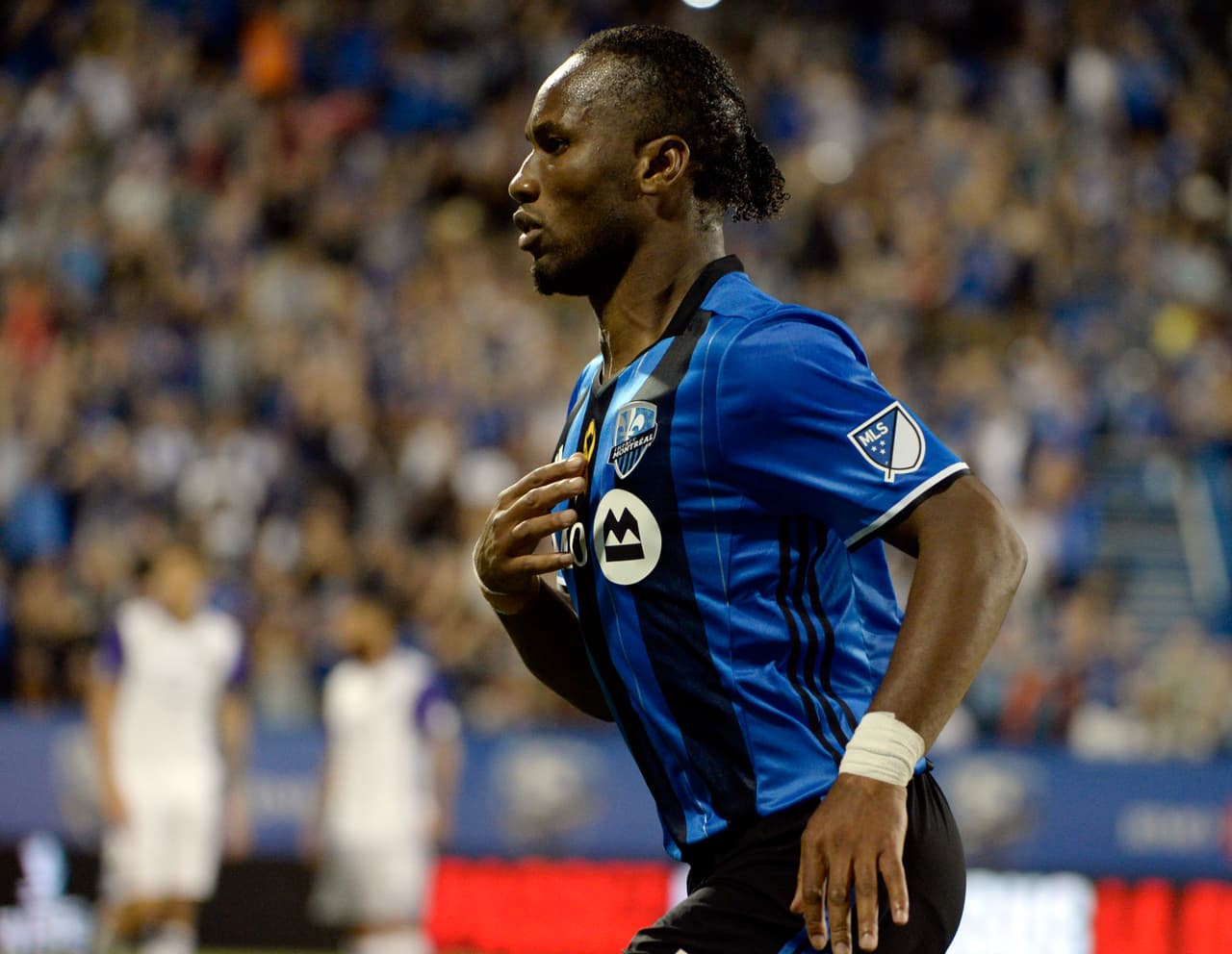 Sep 7, 2016; Montreal, Quebec, CAN; Montreal Impact forward Didier Drogba (11) reacts after scoring a goal Orlando City SC during the first half at Stade Saputo. Mandatory Credit: Eric Bolte-USA TODAY Sports