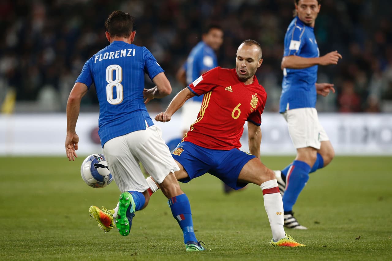 Italy's midfielder Alessandro Florenzi (L) vies with Spain's midfielder Andres Iniesta during the WC 2018 football qualification match between Italy and Spain on October 6, 2016 at the Juventus stadium in Turin / AFP / Marco BERTORELLO (Photo credit should read MARCO BERTORELLO/AFP/Getty Images)
