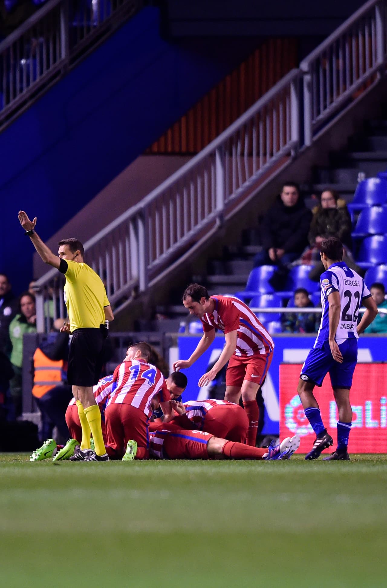 Referee calls for medical assistance after Atletico Madrid's forward Fernando Torres (on the ground) got an injury during the Spanish league football match RC Deportivo de la Coruna vs Club Atletico de Madrid at the Municipal de Riazor stadium in La Coruna on March 2, 2017. The match ended with a 1-1 draw. / AFP PHOTO / MIGUEL RIOPA (Photo credit should read MIGUEL RIOPA/AFP/Getty Images)