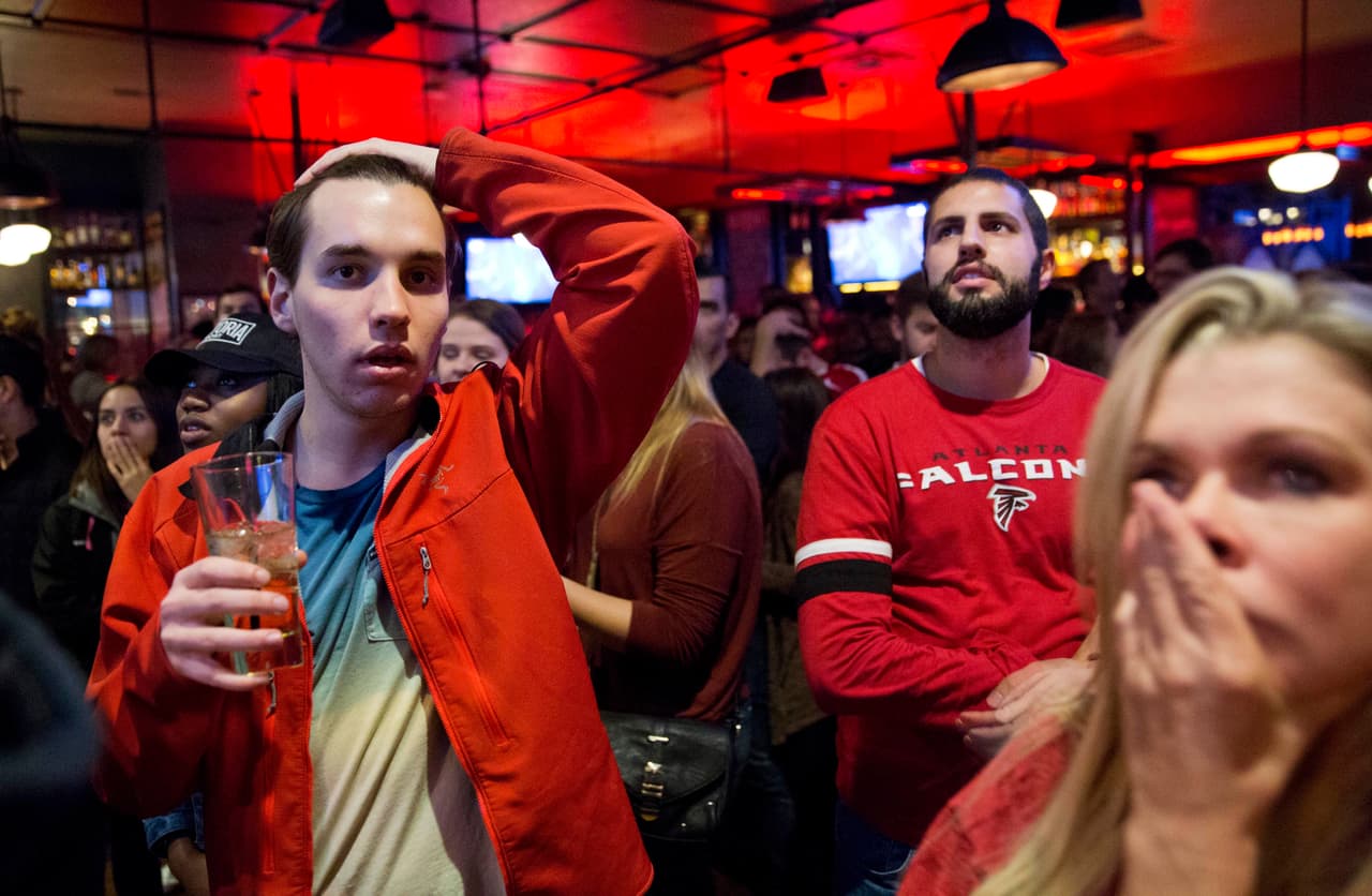 Atlanta Falcons fans react after the New England Patriots beat Atlanta in the NFL Super Bowl 51 football game being played in Houston while watching it on television at Fado Irish Pub in Atlanta, Sunday, Feb. 5, 2017. The Patriots won 34-28 in overtime. (AP Photo/David Goldman)