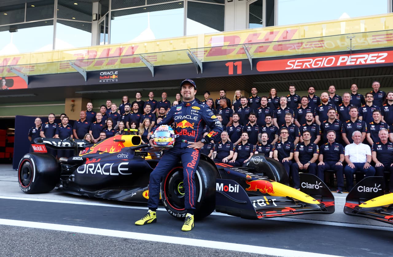 ABU DHABI, UNITED ARAB EMIRATES - NOVEMBER 17: Sergio Perez of Mexico and Oracle Red Bull Racing poses with his team at the Red Bull Racing End of Season Team Photo during previews ahead of the F1 Grand Prix of Abu Dhabi at Yas Marina Circuit on November 17, 2022 in Abu Dhabi, United Arab Emirates. (Photo by Bryn Lennon/Getty Images)