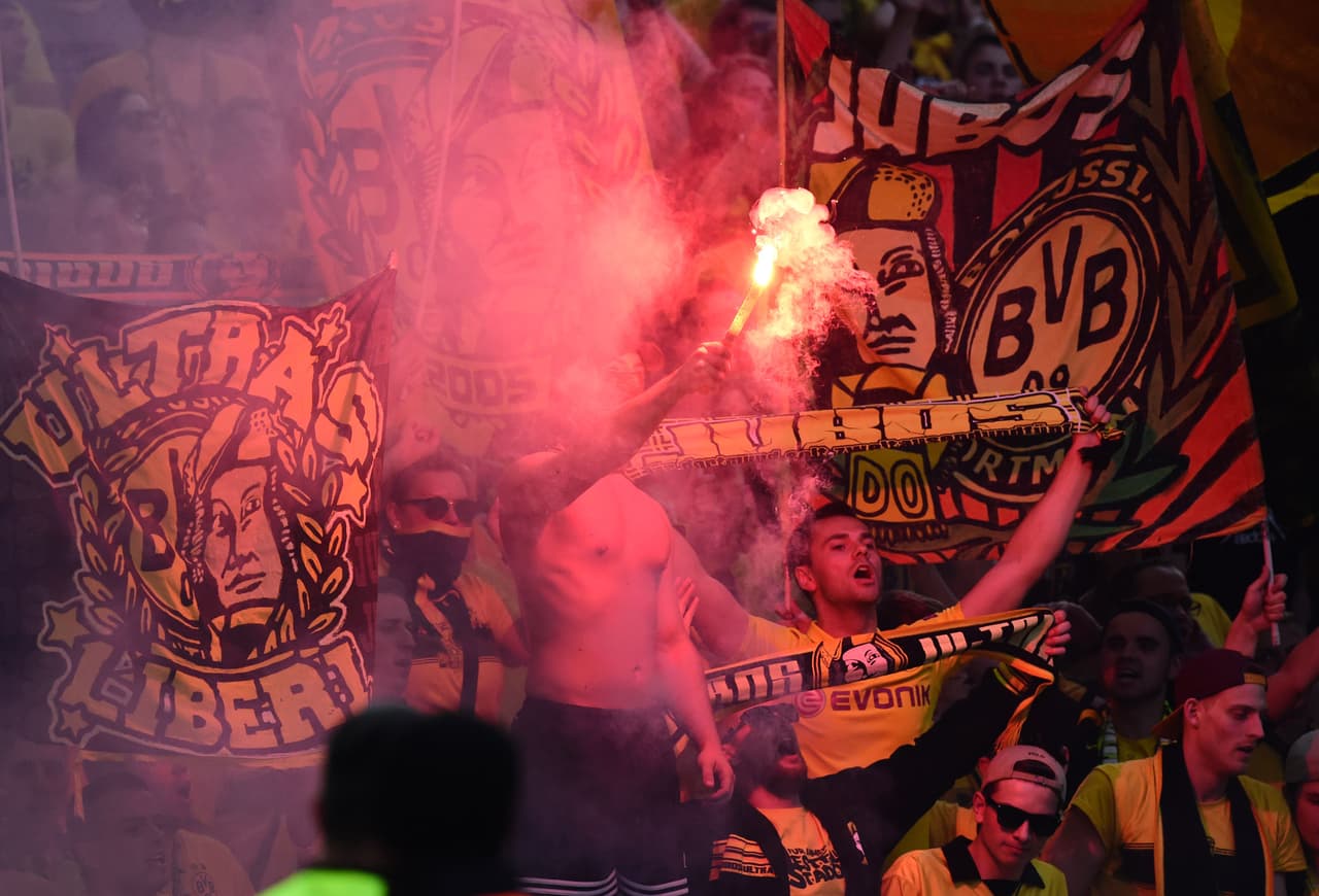 Fireworks are burned by a fan during the German Cup (DFB Pokal) final football match Bayern Munich vs Borussia Dortmund at the Olympic stadium in Berlin on May 21, 2016. / AFP / TOBIAS SCHWARZ / RESTRICTIONS: ACCORDING TO DFB RULES IMAGE SEQUENCES TO SIMULATE VIDEO IS NOT ALLOWED DURING MATCH TIME. MOBILE (MMS) USE IS NOT ALLOWED DURING AND FOR FURTHER TWO HOURS AFTER THE MATCH. == RESTRICTED TO EDITORIAL USE == FOR MORE INFORMATION CONTACT DFB DIRECTLY AT +49 69 67880 / (Photo credit should read TOBIAS SCHWARZ/AFP/Getty Images)