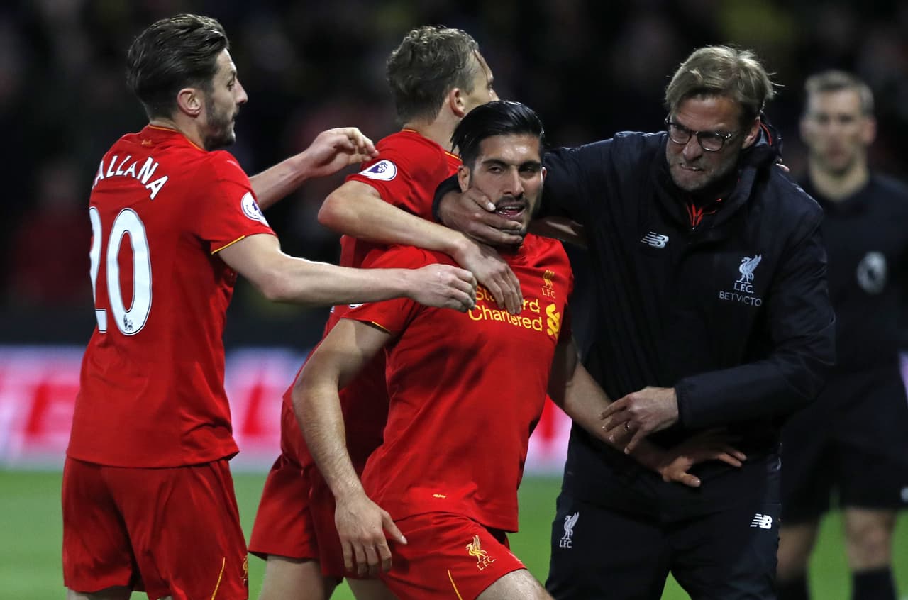 Liverpool's German midfielder Emre Can (C) celebrates with Liverpool's English midfielder Adam Lallana (L), Liverpool's Brazilian midfielder Lucas Leiva (2nd L) and Liverpool's German manager Jurgen Klopp after scoring the opening goal of the English Premier League football match between Watford and Liverpool at Vicarage Road Stadium in Watford, north of London on May 1, 2017. / AFP PHOTO / Adrian DENNIS / RESTRICTED TO EDITORIAL USE. No use with unauthorized audio, video, data, fixture lists, club/league logos or 'live' services. Online in-match use limited to 75 images, no video emulation. No use in betting, games or single club/league/player publications. / (Photo credit should read ADRIAN DENNIS/AFP/Getty Images)