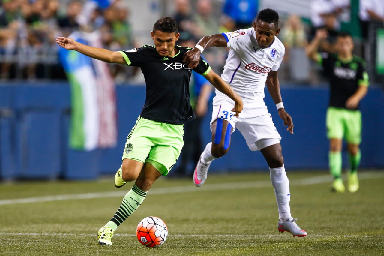 Cristian Roldán y Rommel Quioto disputan una pelota.