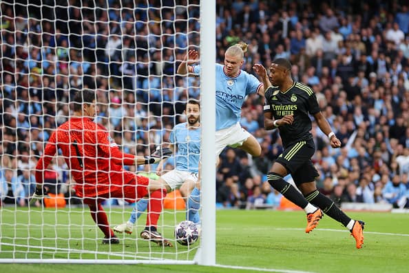 MANCHESTER, ENGLAND - MAY 17: Erling Haaland of Manchester City has a shot saved by Thibaut Courtois of Real Madrid during the UEFA Champions League semi-final second leg match between Manchester City FC and Real Madrid at Etihad Stadium on May 17, 2023 in Manchester, England. (Photo by Clive Brunskill/Getty Images)