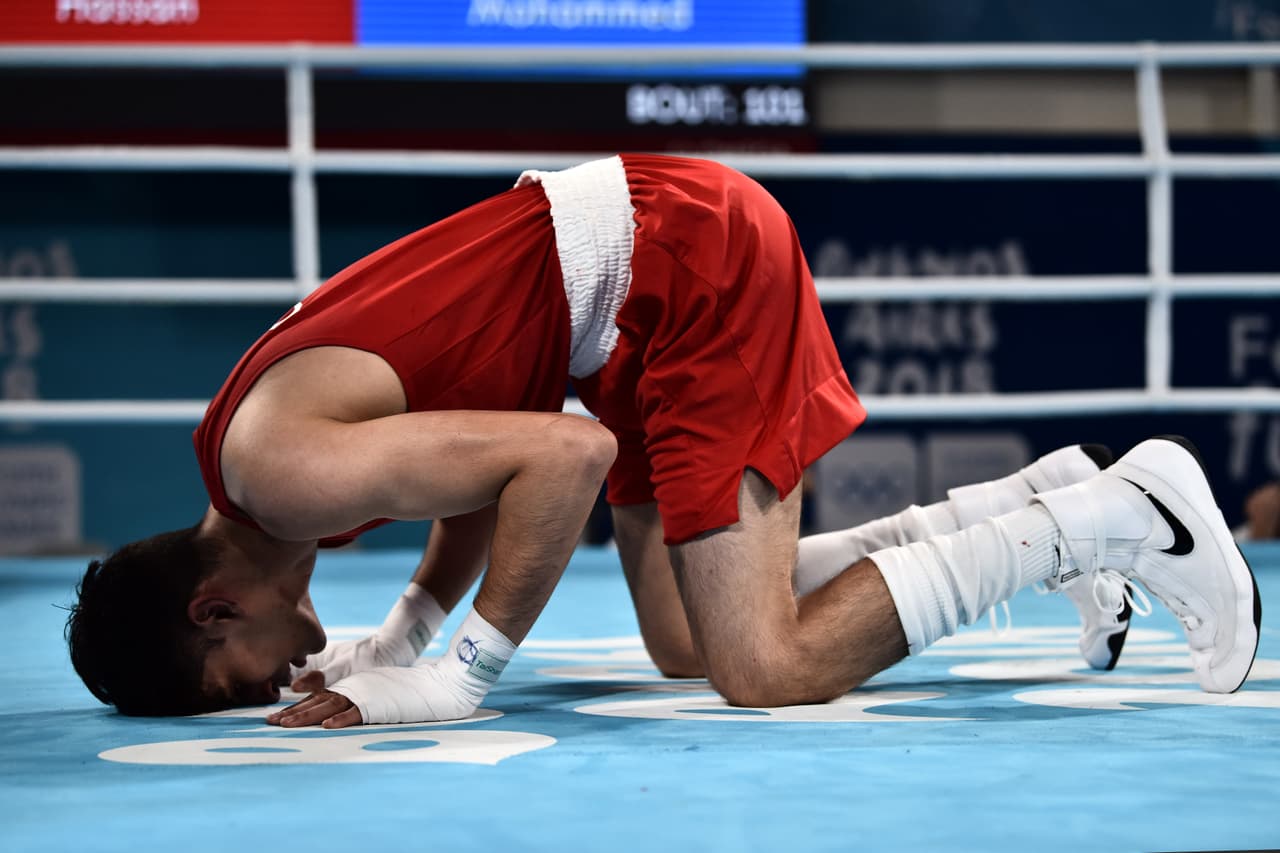 BUENOS AIRES, ARGENTINA - OCTOBER 18: Azim Hassan of Great Britain (red) fights with Mohammed Boulaouja of Morocco (blue) in Men's Light Welter (64kg) Bronze Medal Bout during day 12 of Buenos Aires 2018 Youth Olympic Games at Oceania Pavilion in the Youth Olympic Park on October 18, 2018 in Buenos Aires, Argentina. (Photo by Amilcar Orfali/Getty Images)