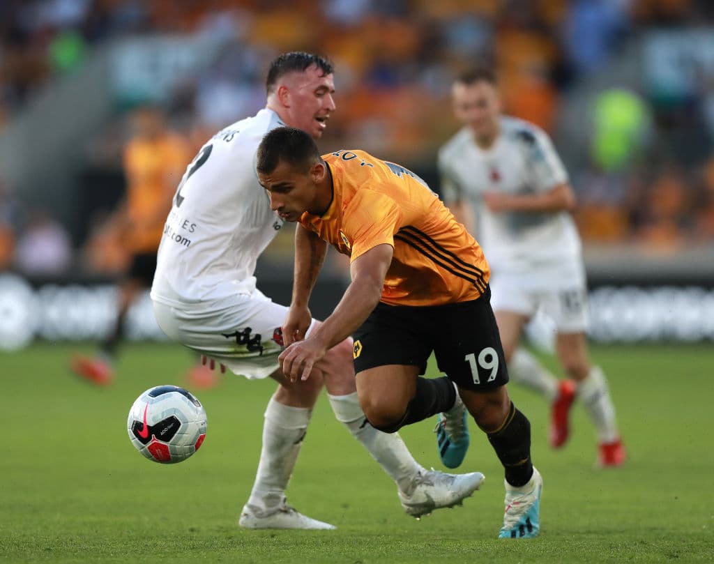 WOLVERHAMPTON, ENGLAND - JULY 25: Jonny of Wolverhampton Wanderers goes past Billy Burns during the UEFA Europa League Second Qualifying round 1st Leg match between Wolverhampton Wanderers and Crusaders at Molineux on July 25, 2019 in Wolverhampton, England. (Photo by David Rogers/Getty Images)