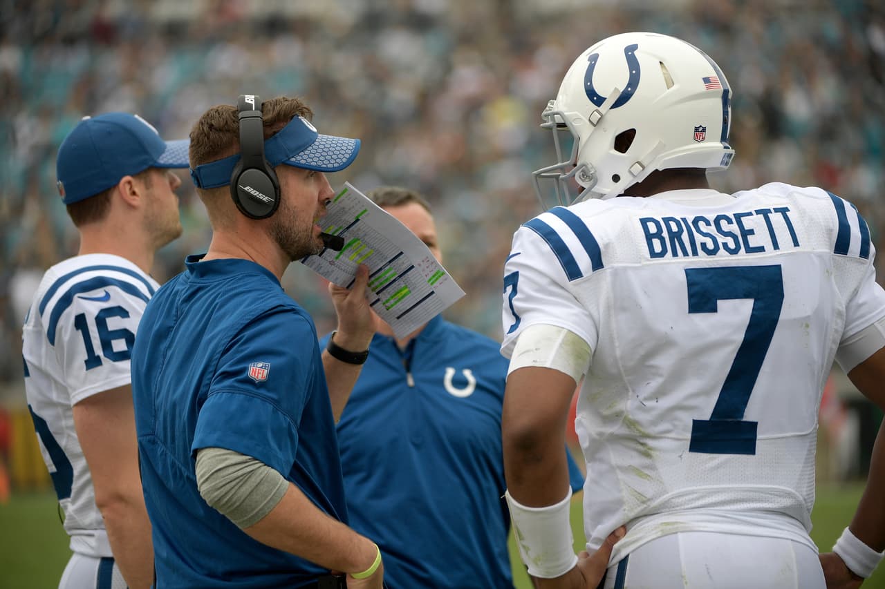 Indianapolis Colts quarterbacks coach Brian Schottenheimer, left, talks with quarterback Jacoby Brissett (7) during the second half of an NFL football game against the Jacksonville Jaguars Sunday, Dec. 3, 2017, in Jacksonville, Fla. The Jaguars won 30-10. (AP Photo/Phelan M. Ebenhack)