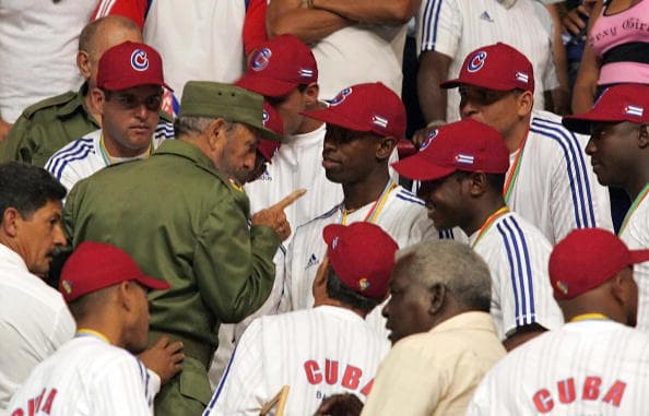 LA HABANA, CUBA: Cuban President Fidel Castro (L) speaks with players of the Cuban baseball national team in Havana 21 March 2006, during a meeting in recognition of the second place obtained in the World Baseball Classic played in San Diego, California, last Monday. During the final, Japan defeated Cuba 10-6. AFP PHOTO/Adalberto ROQUE (Photo credit should read ADALBERTO ROQUE/AFP/Getty Images)