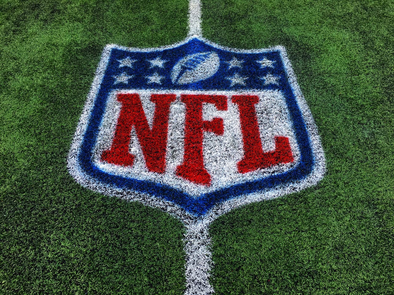 In this photo, altered with an Instagram filter, a detail view of the NFL logo is seen on the field prior to an NFL preseason football game between the Green Bay Packers against the Indianapolis Colts at Tom Benson Hall of Fame Stadium on Sunday, Aug. 7, 2016 in Canton, Ohio. The game was cancelled due to poor playing conditions. (Aaron M. Sprecher via AP)