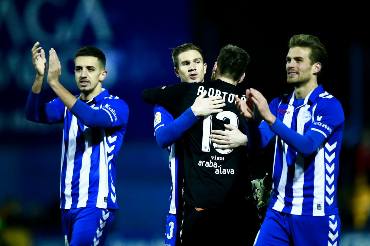ALCORCON, SPAIN - JANUARY 18: Raul Garcia (2ndL) of Deportivo Alaves hugs his teammate goalkeeper Adrian Ortola (2R) surrounded by Zouhair Feddal (L) and Christian Santos (R) after winnig the Copa del Rey quarter-final match between Agrupacion Deportivo Alcorcon and Deportivo Alaves at Santo Domingo stadium on January 18, 2017 in Alcorcon, Spain. (Photo by Gonzalo Arroyo Moreno/Getty Images)