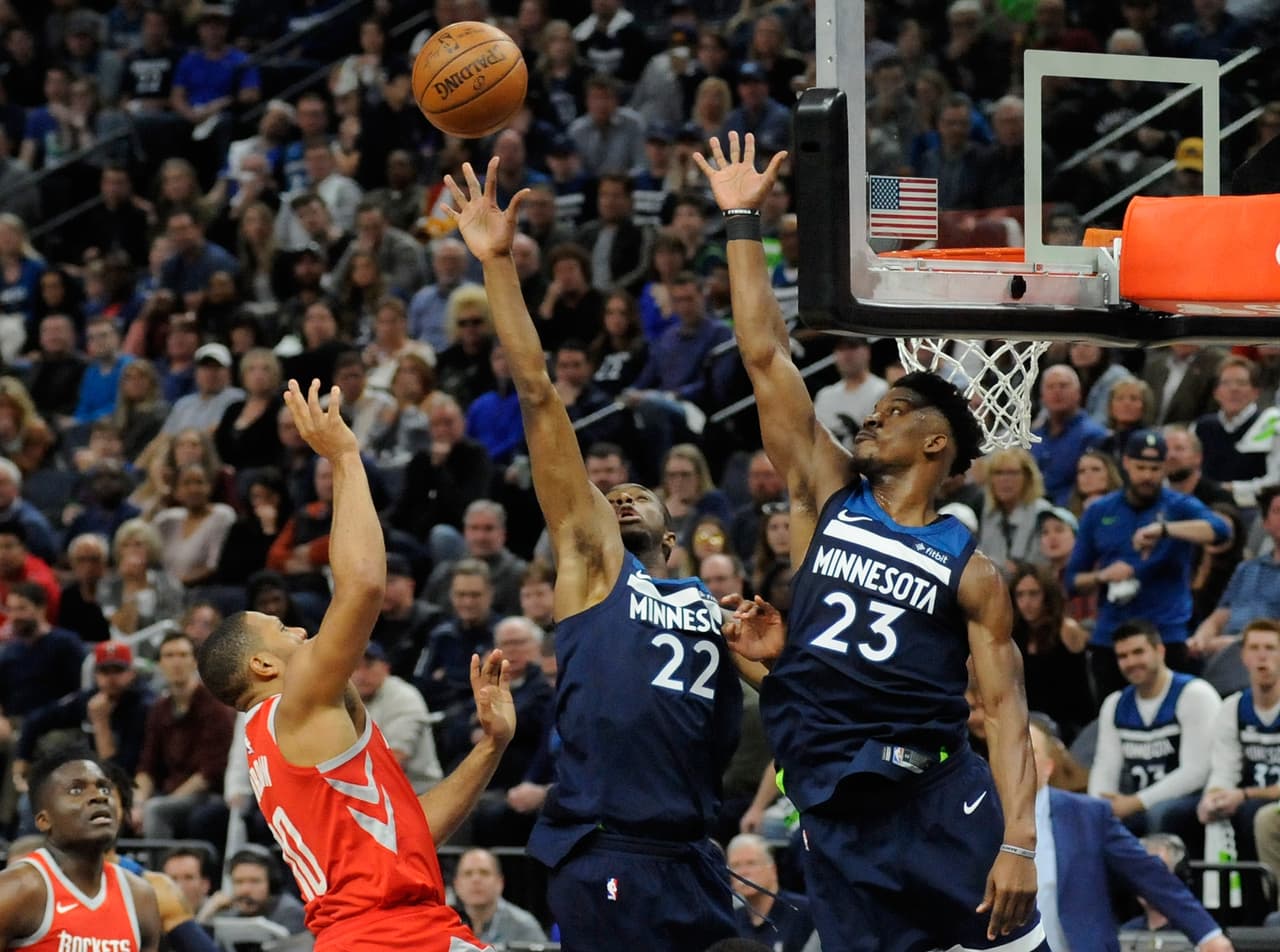MINNEAPOLIS, MN - APRIL 21: Andrew Wiggins #22 and Jimmy Butler #23 of the Minnesota Timberwolves block a shot by Eric Gordon #10 of the Houston Rockets during the fourth quarter in Game Three of Round One of the 2018 NBA Playoffs on April 21, 2018 at the Target Center in Minneapolis, Minnesota. The Timberwolves defeated 121-105. NOTE TO USER: User expressly acknowledges and agrees that, by downloading and or using this Photograph, user is consenting to the terms and conditions of the Getty Images License Agreement. (Photo by Hannah Foslien/Getty Images)