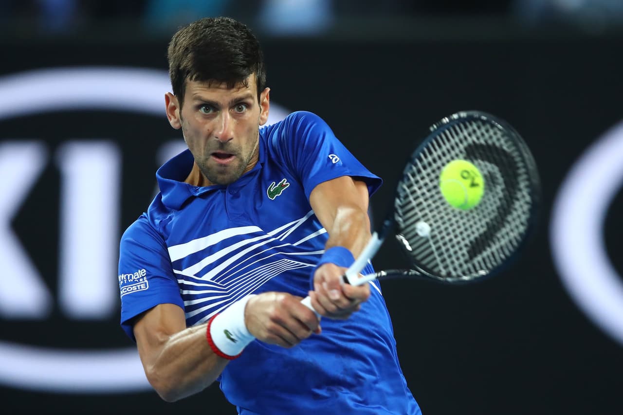 MELBOURNE, AUSTRALIA - JANUARY 23: Novak Djokovic of Serbia plays a backhand in his quarter final match against Kei Nishikori of Japan during day 10 of the 2019 Australian Open at Melbourne Park on January 23, 2019 in Melbourne, Australia. (Photo by Julian Finney/Getty Images)