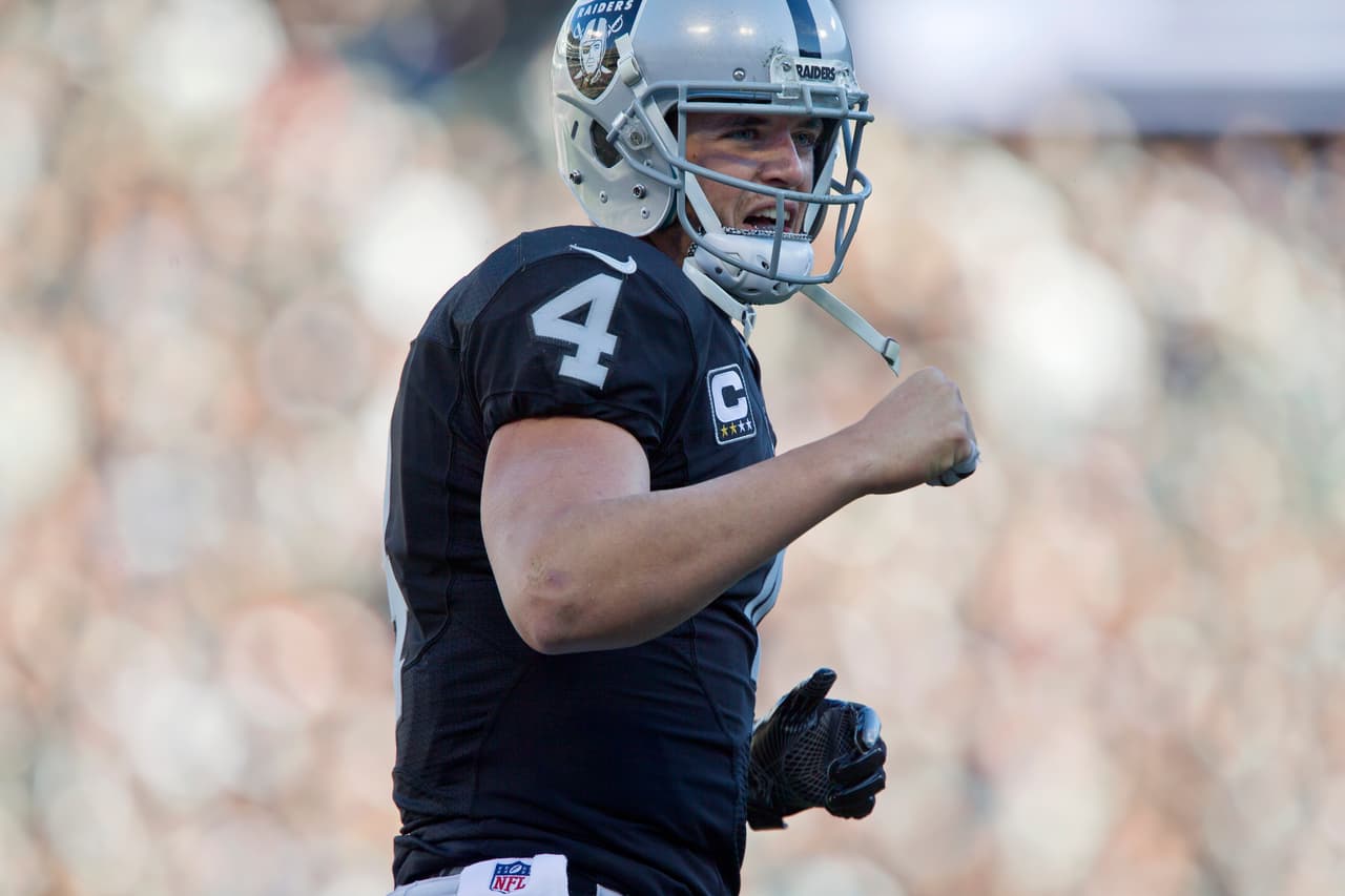 OAKLAND, CA - DECEMBER 24: Quarterback Derek Carr #4 of the Oakland Raiders celebrates a touchdown against the Indianapolis Colts in the third quarter on December 24, 2016 at Oakland-Alameda County Coliseum in Oakland, California. The Raiders won 33-25. (Photo by Brian Bahr/Getty Images)