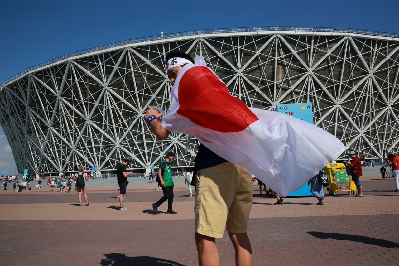 A soccer fan wearing a Japanese flag arrives for the group H match between Japan and Poland at the 2018 soccer World Cup at the Volgograd Arena in Volgograd, Russia, Thursday, June 28, 2018. (AP Photo/Eugene Hoshiko)