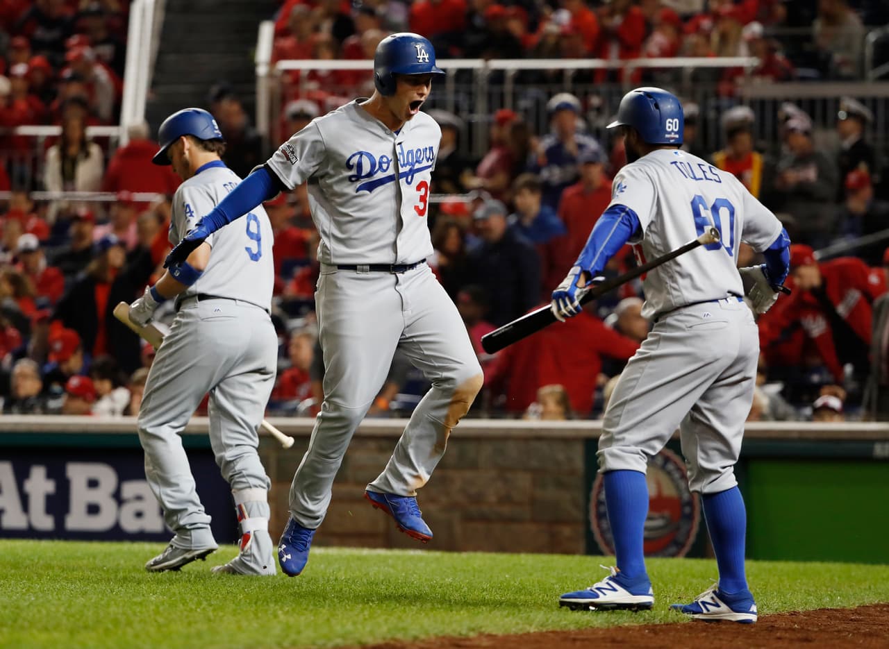 Los Angeles Dodgers Joc Pederson (31) celebrates his solo home run with teammates Yasmani Grandal (9) and Andrew Toles (60) during the seventh inning against the Washington Nationals in a baseball National League Division Series, at Nationals Park, Thursday, Oct. 13, 2016, in Washington. (AP Photo/Pablo Martinez Monsivais)