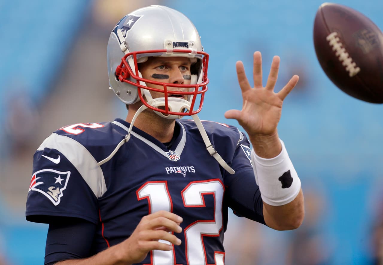FILE - In this Aug. 26, 2016 file photo, New England Patriots quarterback Tom Brady warms up before an NFL preseason football game against the Carolina Panthers in Charlotte, N.C. A lot has happened in the first month of the season since Tom Brady began his four-game suspension. He is eligible to return to the team on Monday, Oct. 3. (AP Photo/Bob Leverone)