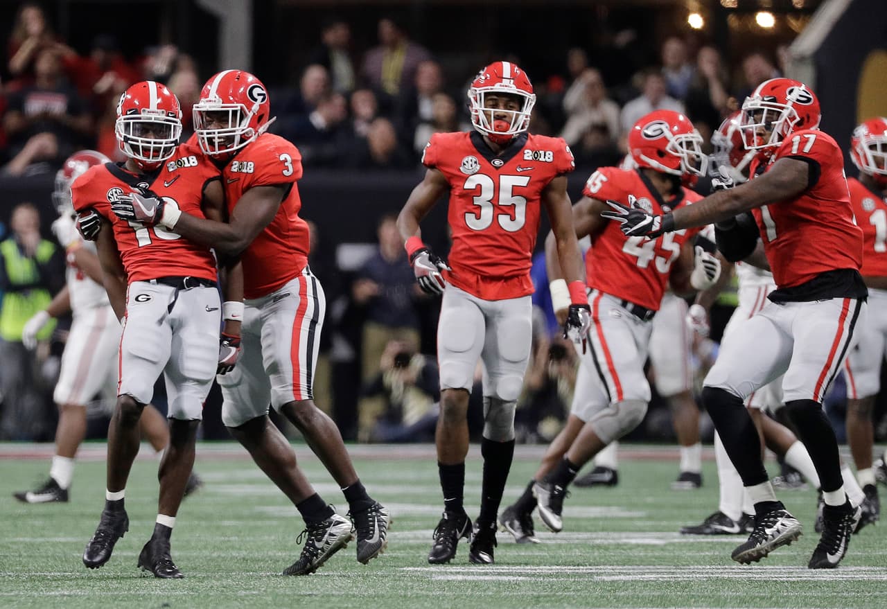 Georgia's Deandre Baker is congratulated after intercepting a pass during the second half of the NCAA college football playoff championship game against Alabama Monday, Jan. 8, 2018, in Atlanta. (AP Photo/David J. Phillip)