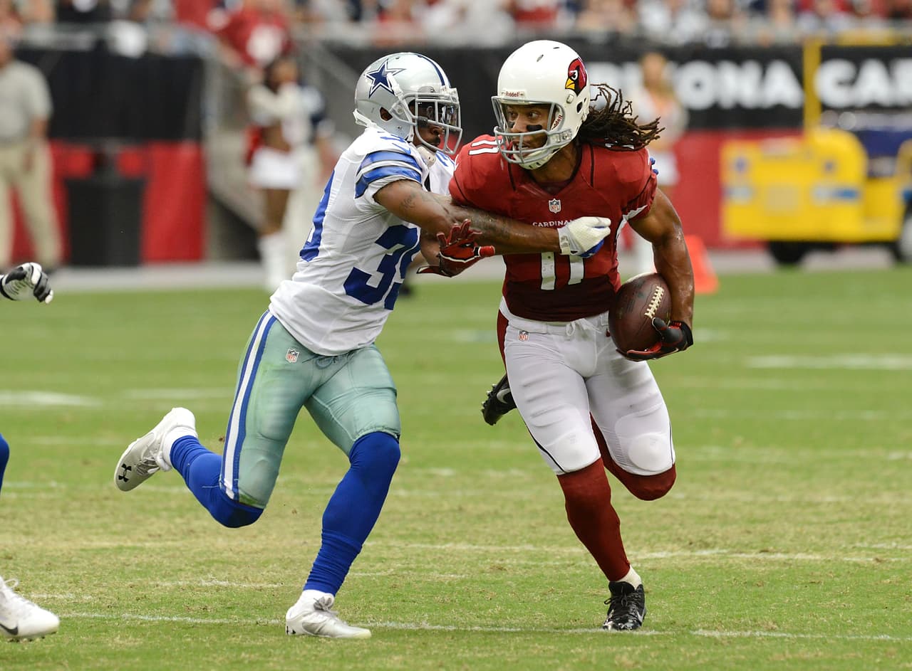 GLENDALE, AZ - AUGUST 17: Larry Fitzgerald #11 of the Arizona Cardinals runs with the ball while being chased by Brandon Carr #39 of the Dallas Cowboys at University of Phoenix Stadium on August 17, 2013 in Glendale, Arizona. (Photo by Norm Hall/Getty Images)