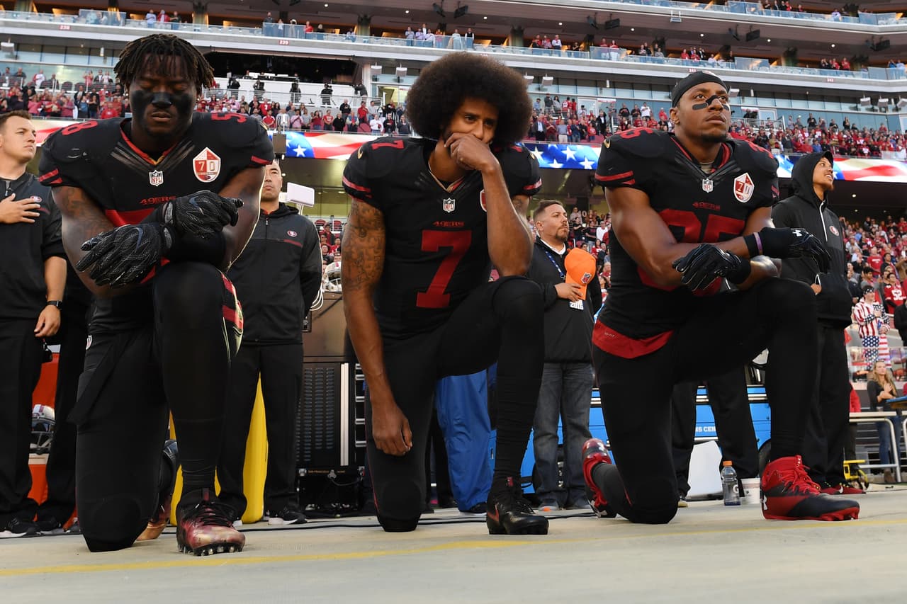 SANTA CLARA, CA - OCTOBER 06: (L-R) Eli Harold #58, Colin Kaepernick #7, and Eric Reid #35 of the San Francisco 49ers kneel in protest during the national anthem prior to their NFL game against the Arizona Cardinals at Levi's Stadium on October 6, 2016 in Santa Clara, California. (Photo by Thearon W. Henderson/Getty Images)