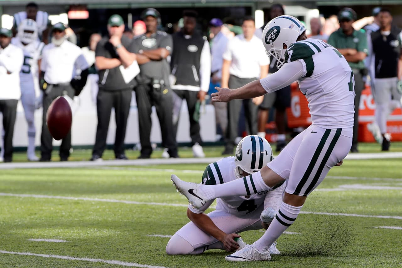 New York Jets kicker Chandler Catanzaro, right, kicks the game winning field goal during the overtime period of an NFL football game against the Jacksonville Jaguars, Sunday, Oct. 1, 2017, in East Rutherford, N.J. The Jets defeated the Jaguars 23-20. (AP Photo/Frank Franklin II)